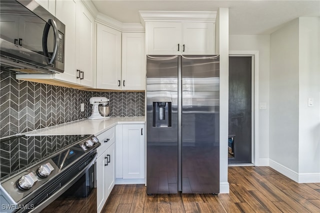 kitchen featuring white cabinetry, appliances with stainless steel finishes, and dark hardwood / wood-style floors