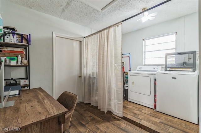 washroom with dark hardwood / wood-style floors, a textured ceiling, washing machine and clothes dryer, and ceiling fan