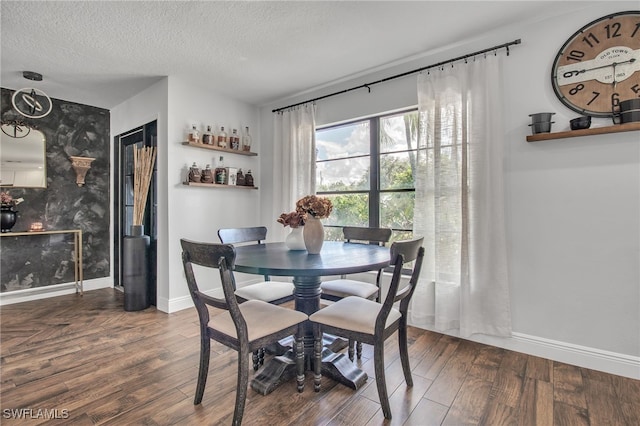 dining space featuring a textured ceiling and dark hardwood / wood-style floors