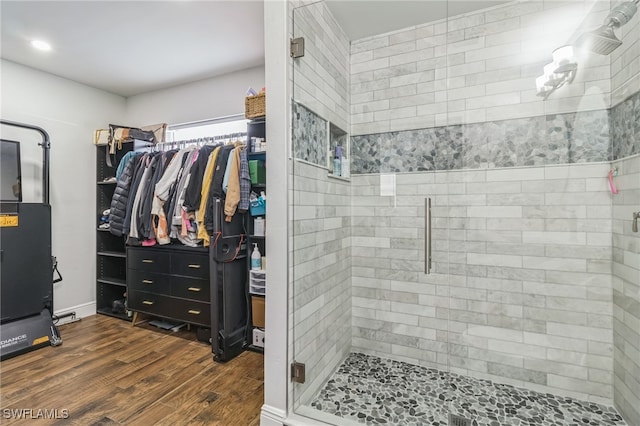 bathroom with an enclosed shower and hardwood / wood-style floors