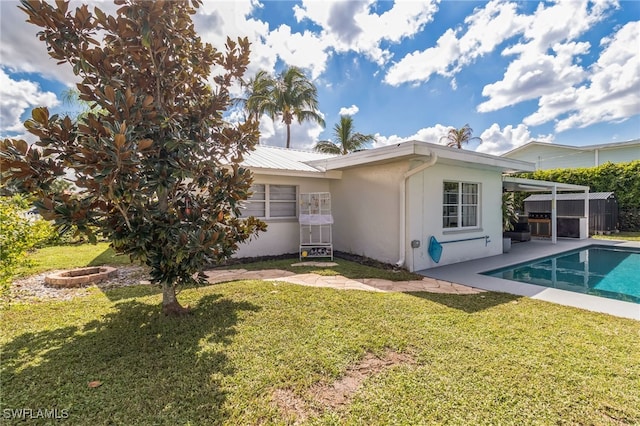 rear view of house featuring a patio and a lawn