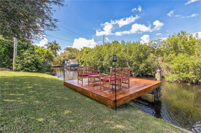 dock area featuring a water view and a yard