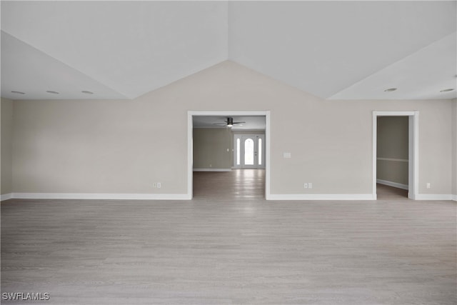 spare room featuring light hardwood / wood-style flooring, lofted ceiling, and ceiling fan