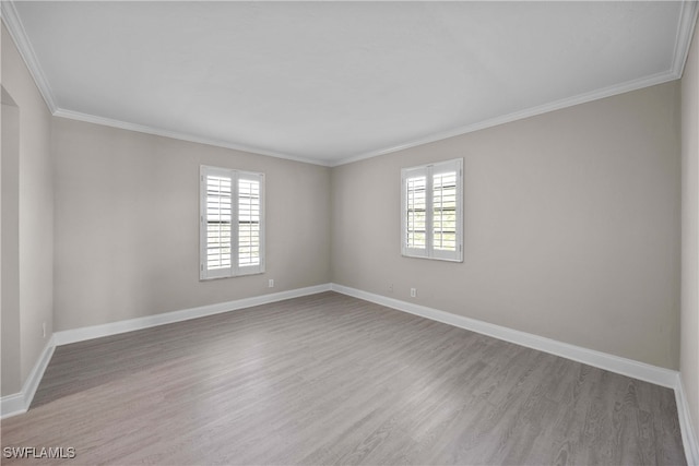 unfurnished room featuring ornamental molding and hardwood / wood-style flooring