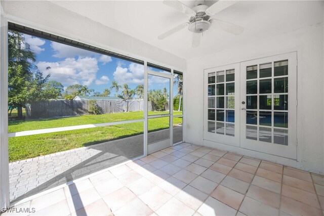 unfurnished sunroom featuring french doors and ceiling fan