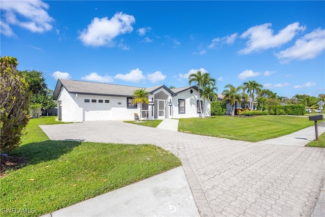 ranch-style house featuring a front yard and a garage