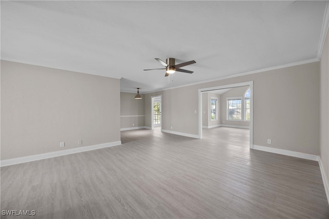 empty room featuring ceiling fan, crown molding, and hardwood / wood-style floors