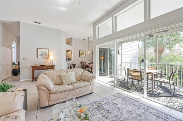 living room with a notable chandelier and light tile patterned floors