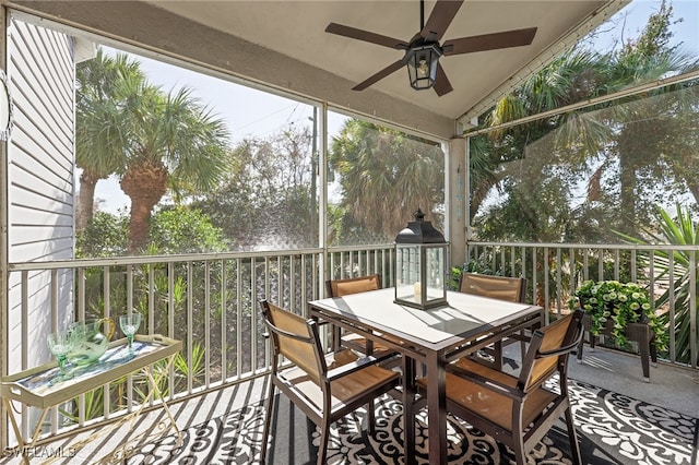 sunroom / solarium with ceiling fan, vaulted ceiling, and a wealth of natural light