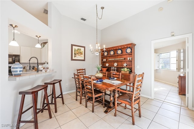 dining area with vaulted ceiling, a notable chandelier, and light tile patterned flooring