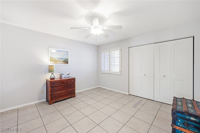 tiled bedroom with a closet and ceiling fan