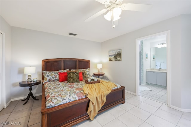 tiled bedroom featuring ceiling fan and ensuite bath