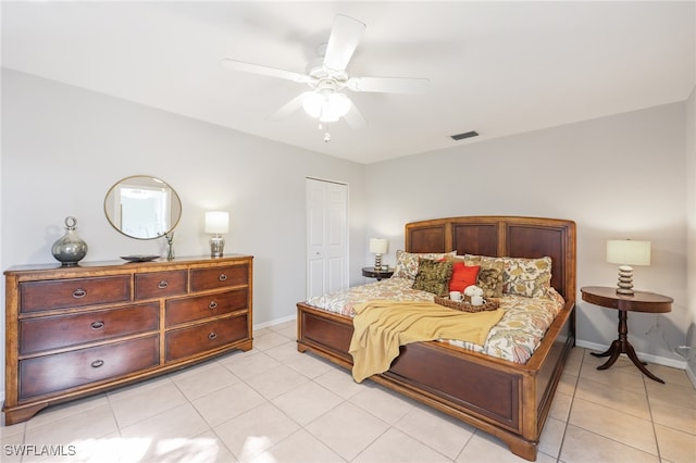 bedroom featuring a closet, ceiling fan, and light tile patterned floors