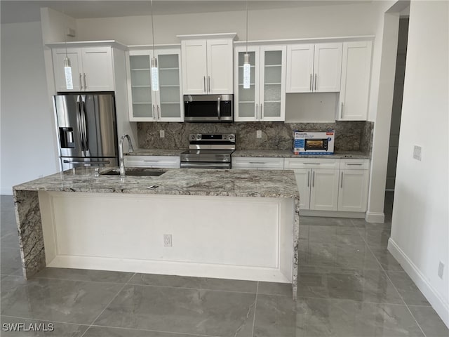 kitchen featuring appliances with stainless steel finishes, white cabinets, sink, and backsplash