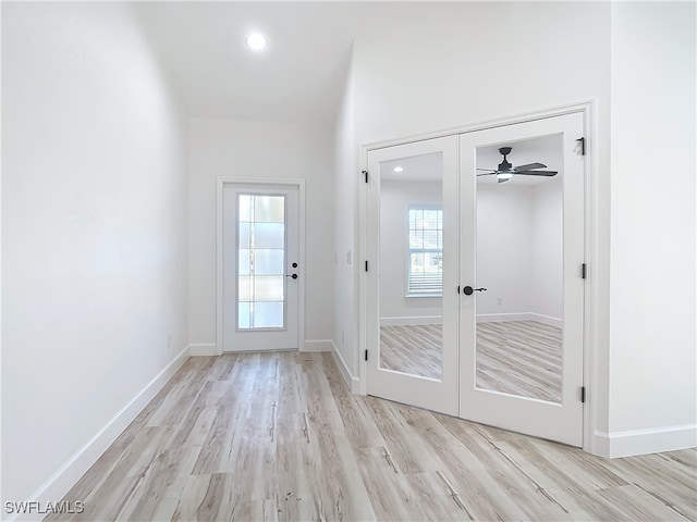 doorway featuring ceiling fan, light hardwood / wood-style flooring, and french doors