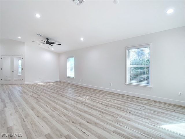 unfurnished living room with ceiling fan, light hardwood / wood-style floors, and vaulted ceiling