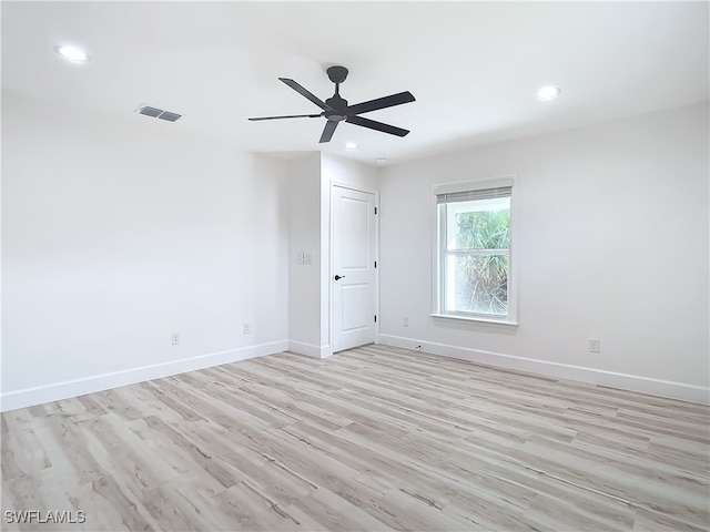 spare room featuring ceiling fan and light wood-type flooring