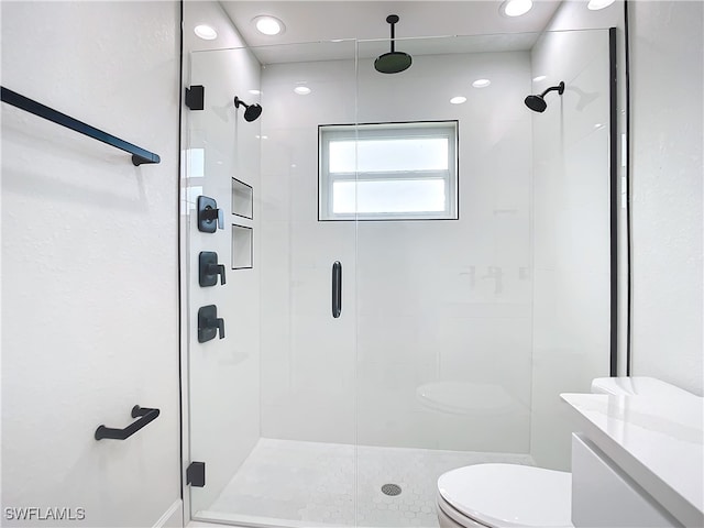 bathroom featuring vanity, toilet, and walk in shower