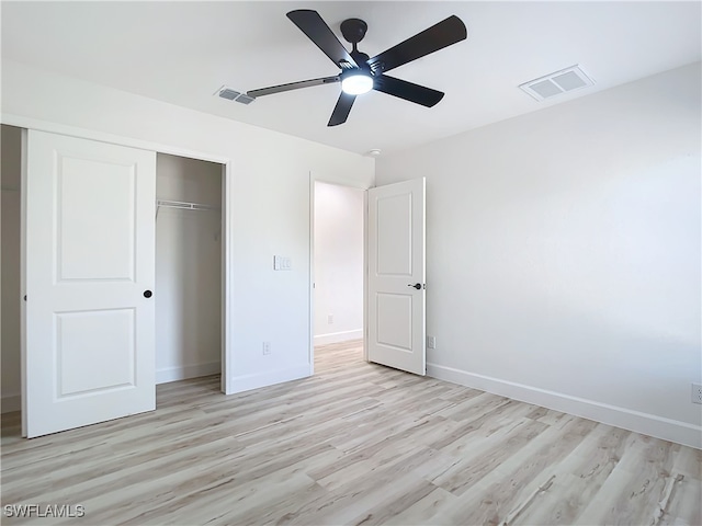 unfurnished bedroom with a closet, light hardwood / wood-style floors, and ceiling fan