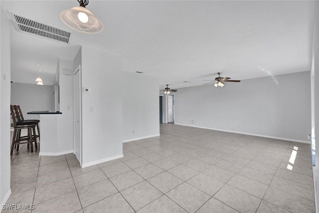 unfurnished living room with light tile patterned flooring and ceiling fan