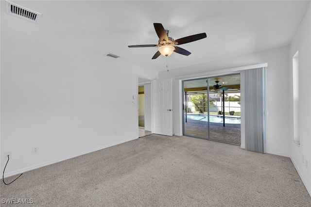 carpeted empty room featuring ceiling fan