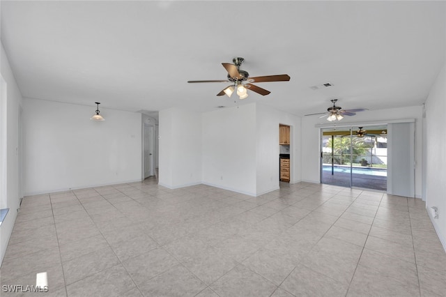 tiled spare room featuring ceiling fan