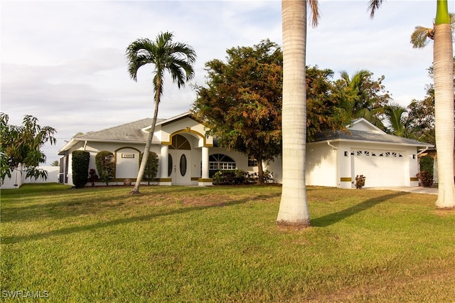 view of front of home with a front lawn and a garage