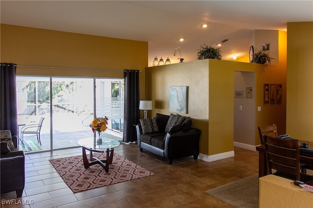 tiled living room featuring lofted ceiling