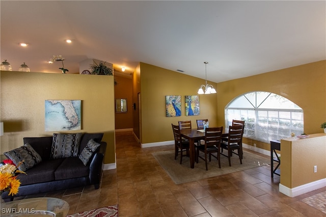 dining space featuring a chandelier and vaulted ceiling