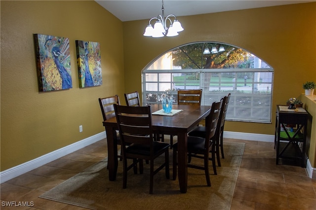 tiled dining area with vaulted ceiling and a notable chandelier