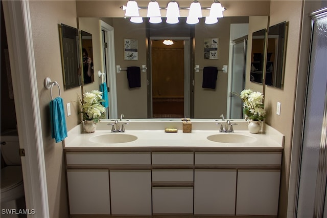 bathroom featuring vanity and toilet