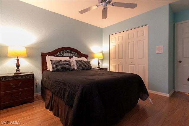 bedroom featuring light hardwood / wood-style floors, a closet, and ceiling fan