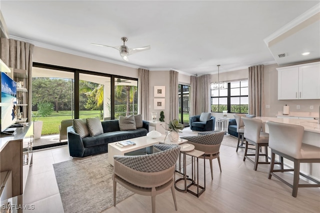 living room with crown molding and ceiling fan with notable chandelier