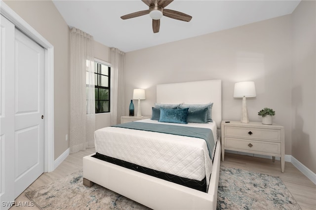 bedroom with a closet, light wood-type flooring, and ceiling fan