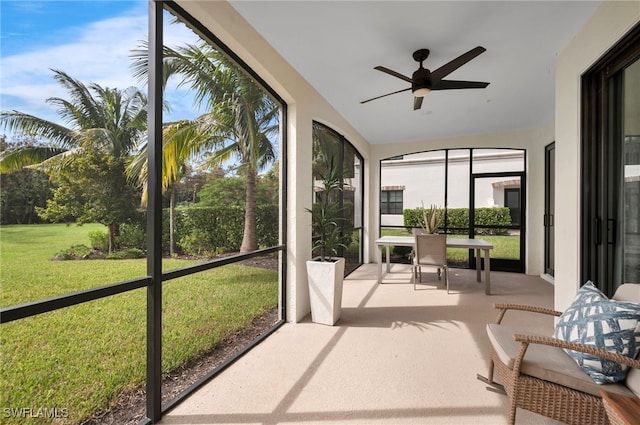 sunroom featuring ceiling fan and vaulted ceiling