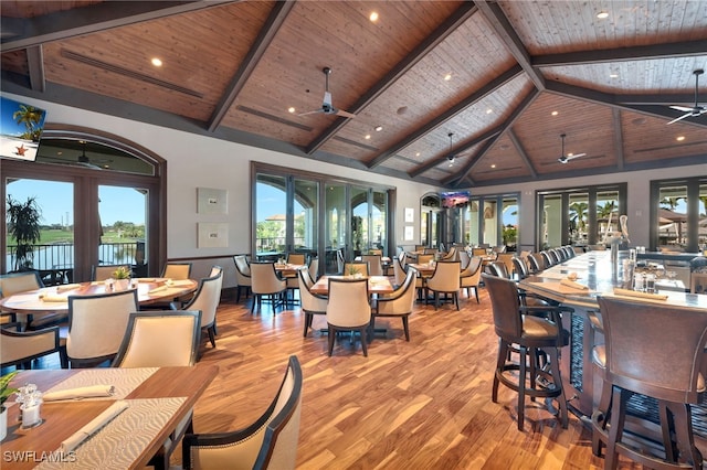 dining area with light hardwood / wood-style flooring, french doors, wood ceiling, and ceiling fan