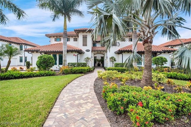 mediterranean / spanish-style house featuring a front yard