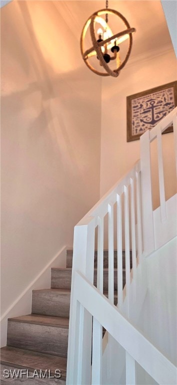 stairs with an inviting chandelier