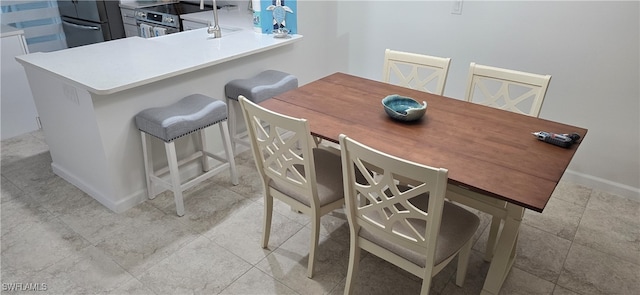 dining space featuring light tile patterned floors