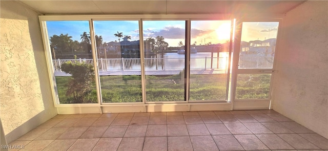 unfurnished sunroom with a water view and plenty of natural light