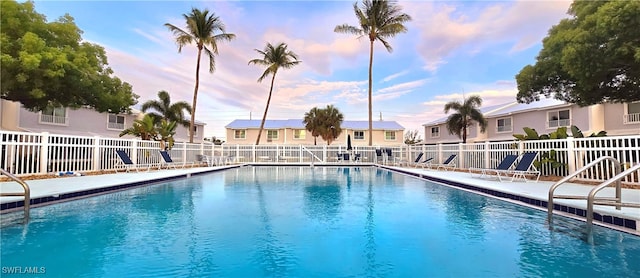 view of pool at dusk