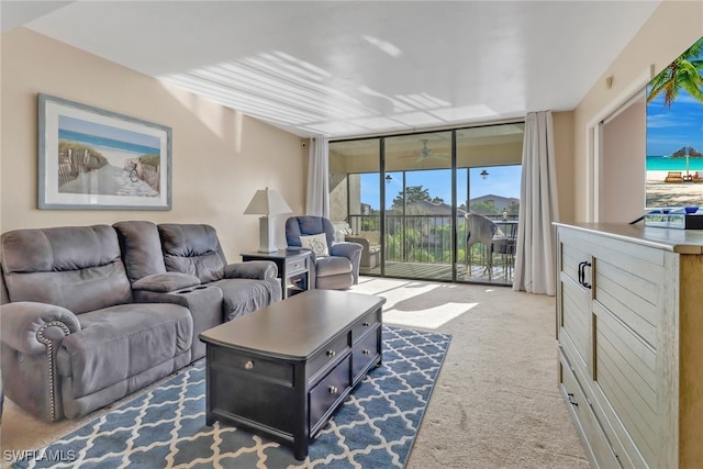 living room featuring expansive windows and dark colored carpet