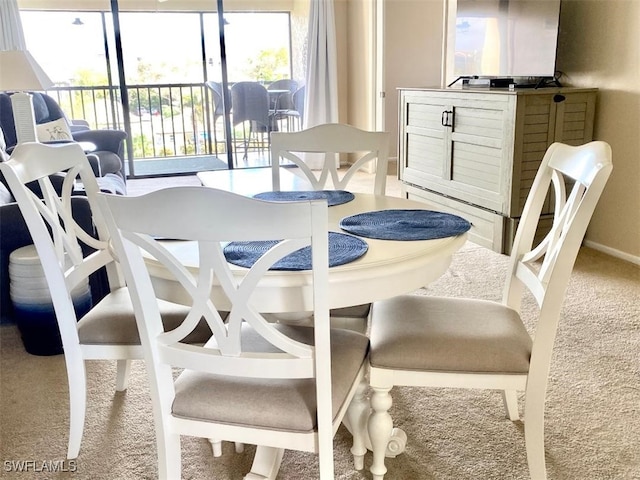 dining space with carpet flooring