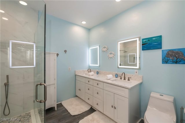 bathroom featuring hardwood / wood-style flooring, vanity, toilet, and walk in shower