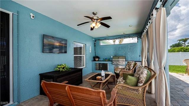 sunroom / solarium featuring ceiling fan