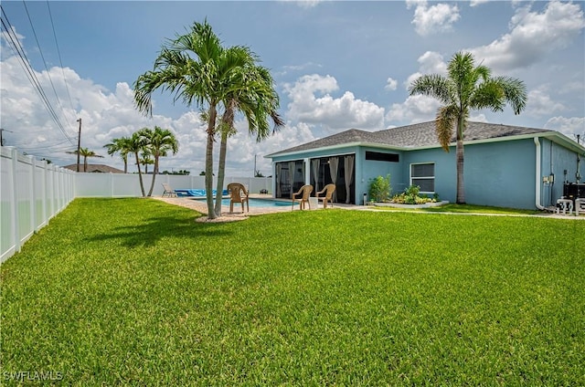 view of yard with a fenced in pool and a patio area