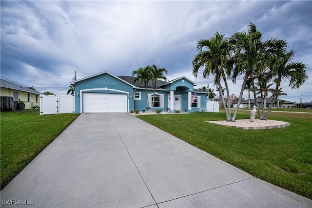 ranch-style home featuring a garage, a front yard, and central AC