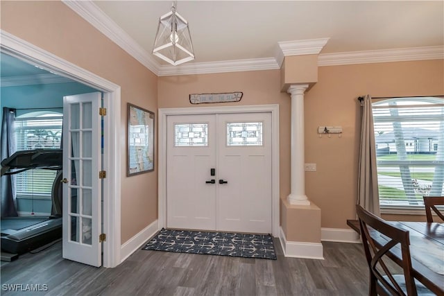 entrance foyer with ornate columns, plenty of natural light, and ornamental molding