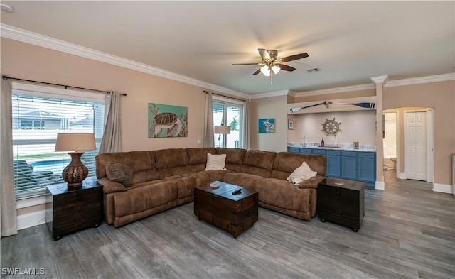 living room with ceiling fan, dark hardwood / wood-style flooring, and ornamental molding