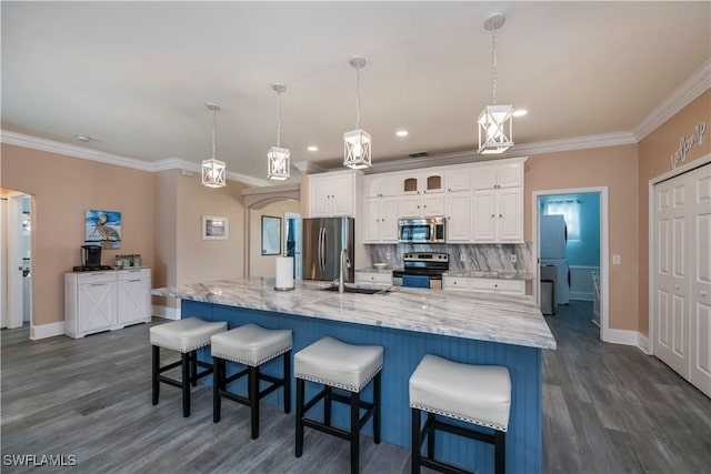 kitchen with white cabinets, a spacious island, stainless steel appliances, and hanging light fixtures